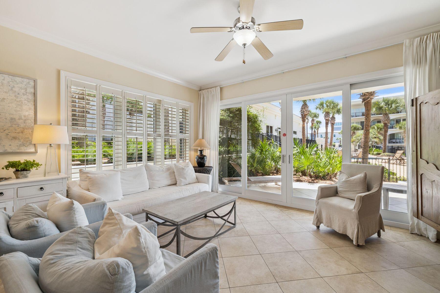 2421 West County Highway 30A, Unit D101 Santa Rosa Beach, FL 32459 - Photo 3 of 44 a living room with furniture and floor to ceiling windows
