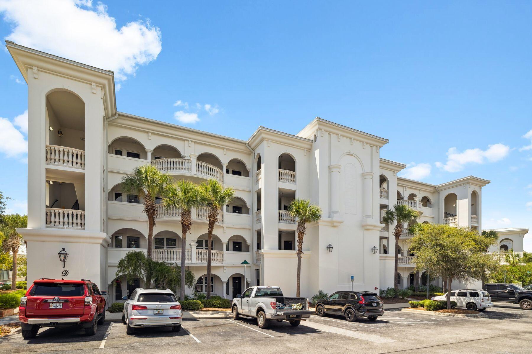 2421 West County Highway 30A, Unit D101 Santa Rosa Beach, FL 32459 - Photo 39 of 44 a front view of a building with lot of cars and trees