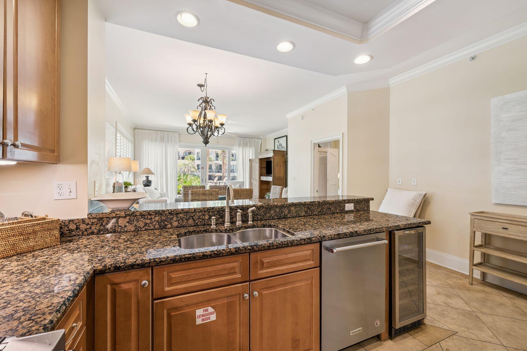 2421 West County Highway 30A, Unit D101 Santa Rosa Beach, FL 32459 - Photo 6 of 44 a kitchen with a sink and a refrigerator