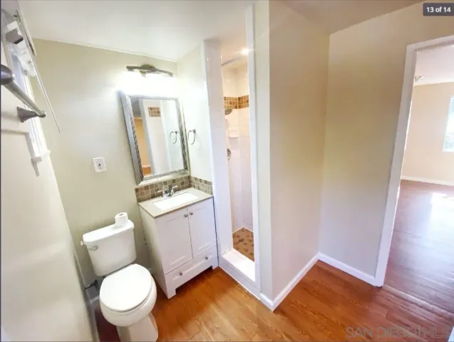 a bathroom with a granite countertop toilet sink and a mirror