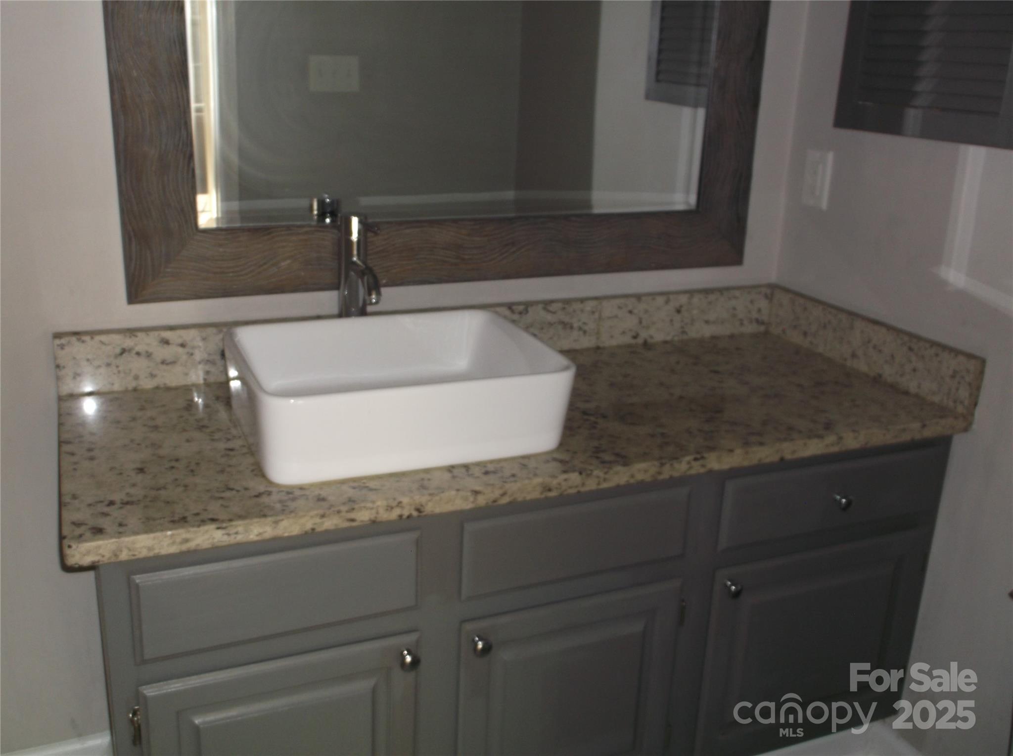 5007 Sharon Road, Unit O Charlotte, NC 28210 - Photo 11 of 20 a bathroom with a granite countertop sink and a mirror