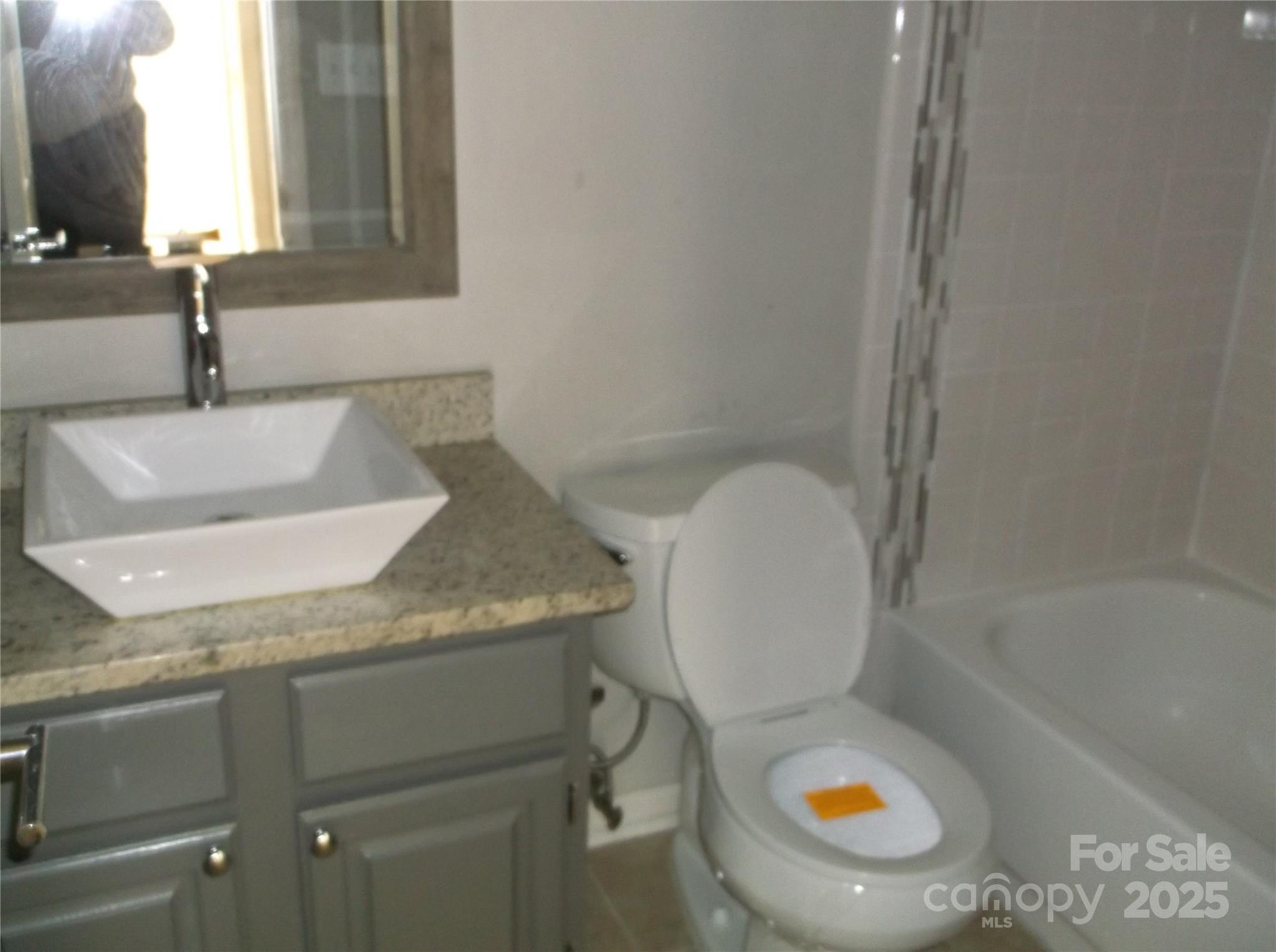 5007 Sharon Road, Unit O Charlotte, NC 28210 - Photo 14 of 20 a bathroom with a granite countertop sink and a mirror
