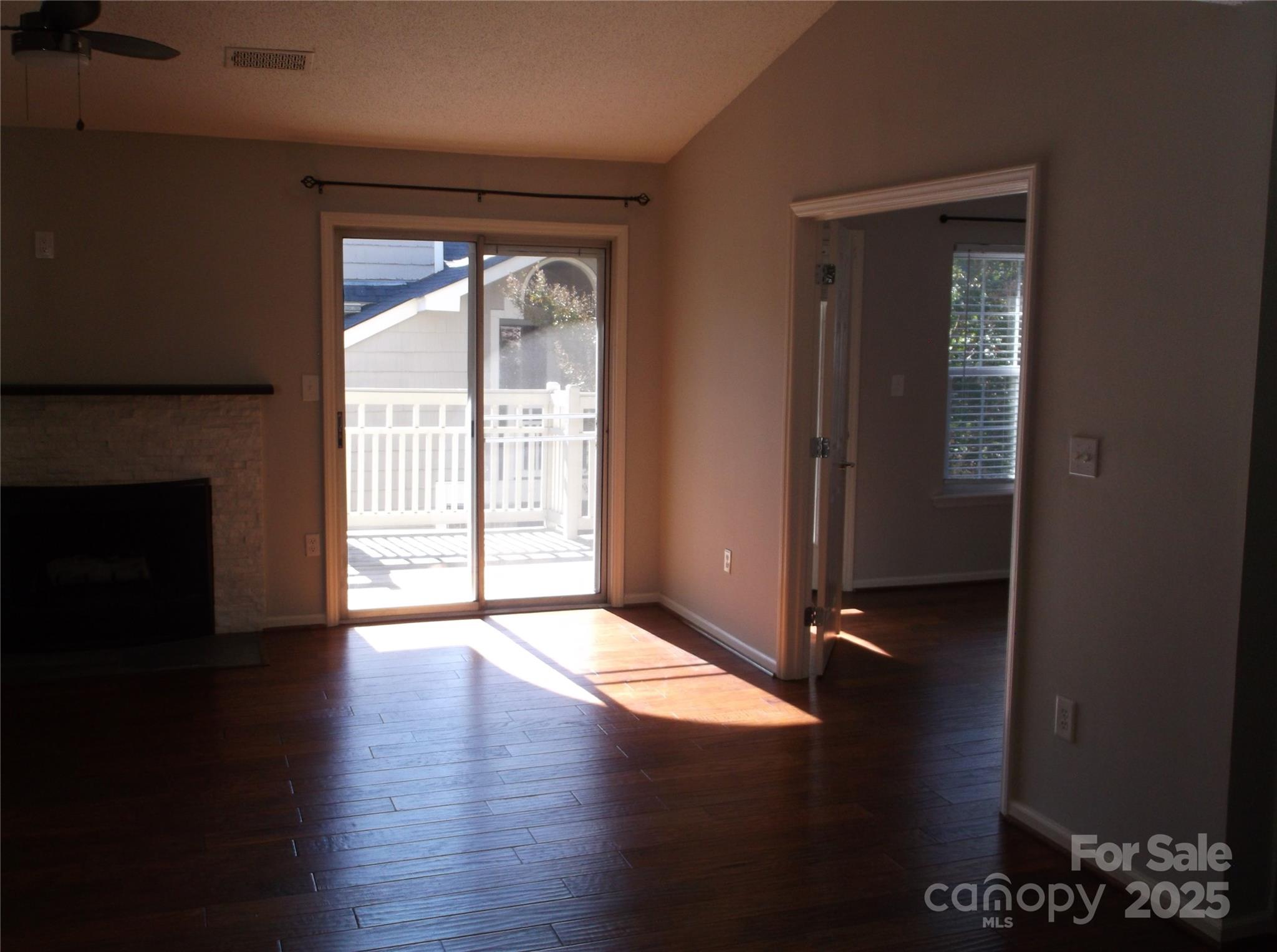 5007 Sharon Road, Unit O Charlotte, NC 28210 - Photo 17 of 20 an empty room with wooden floor and windows