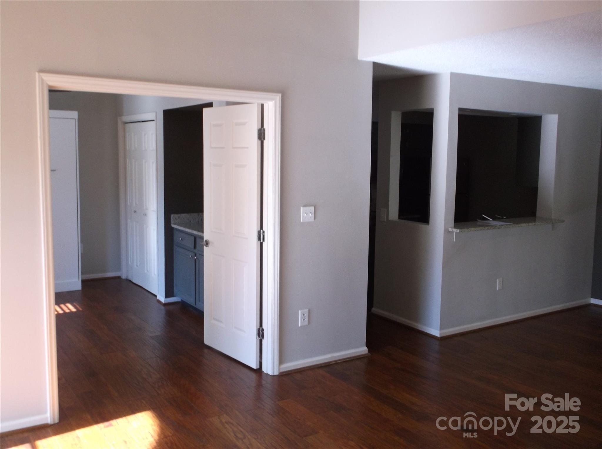 5007 Sharon Road, Unit O Charlotte, NC 28210 - Photo 19 of 20 a view of a hallway with wooden floor and cabinets