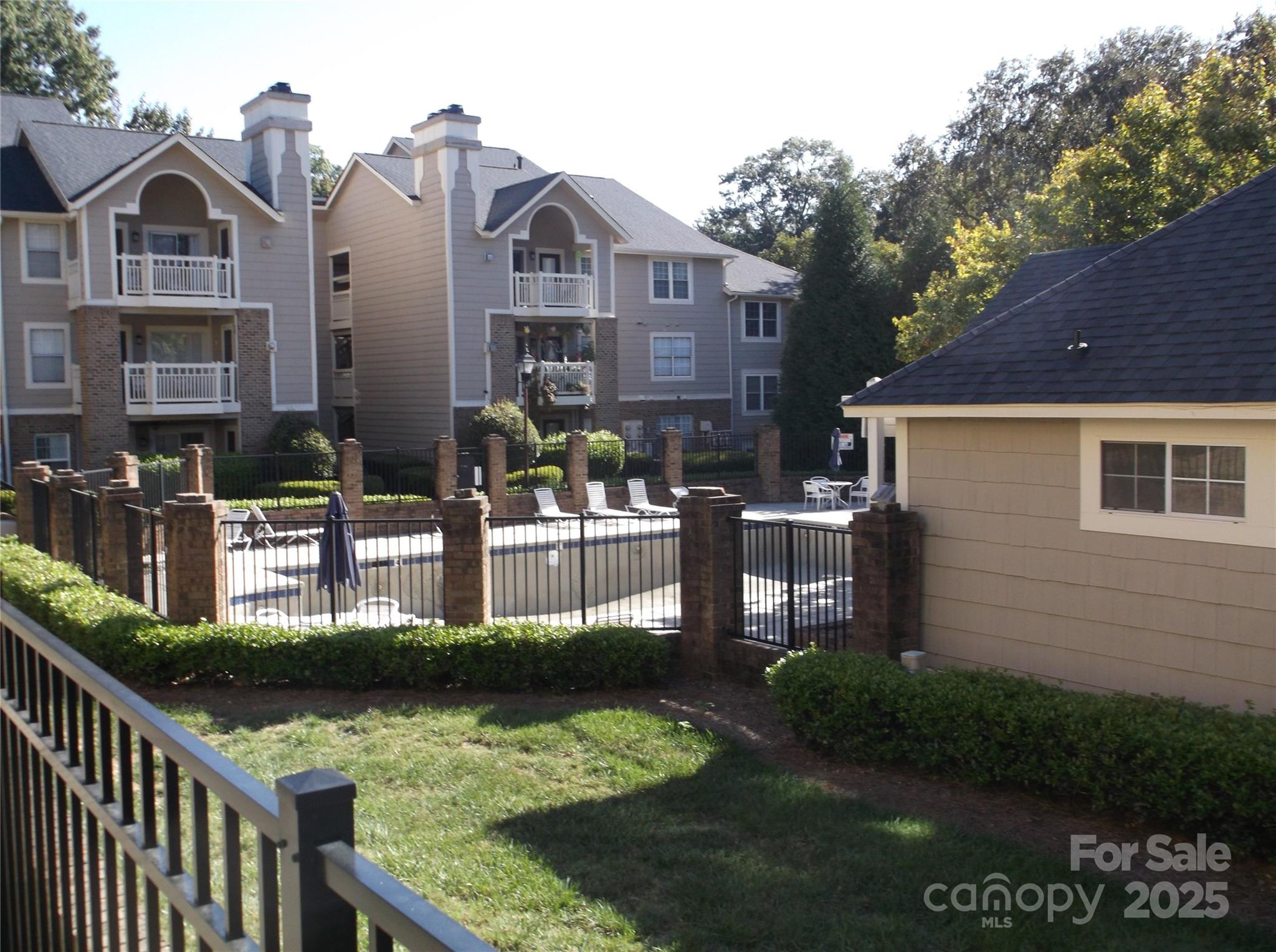 5007 Sharon Road, Unit O Charlotte, NC 28210 - Photo 3 of 20 a front view of a house with garden