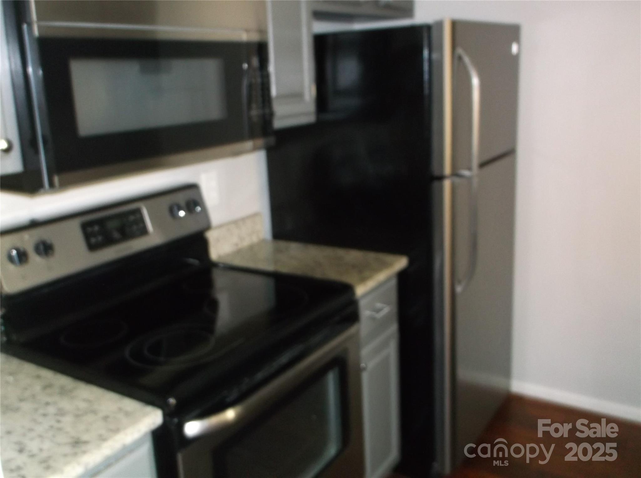 5007 Sharon Road, Unit O Charlotte, NC 28210 - Photo 9 of 20 a kitchen with a stove and a microwave