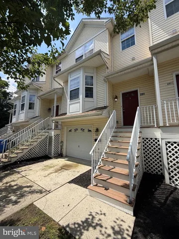 a view of a house with wooden deck front of house