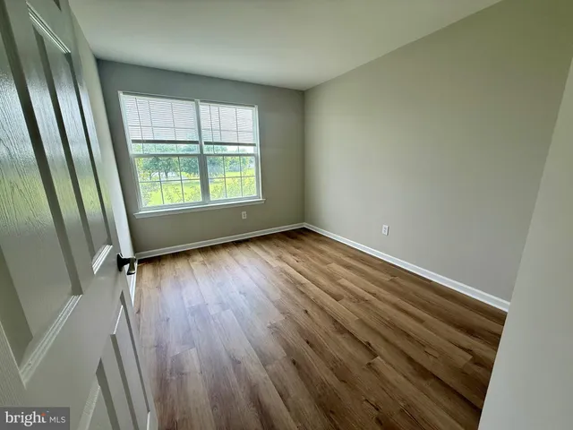 a view of a room with wooden floor and staircase