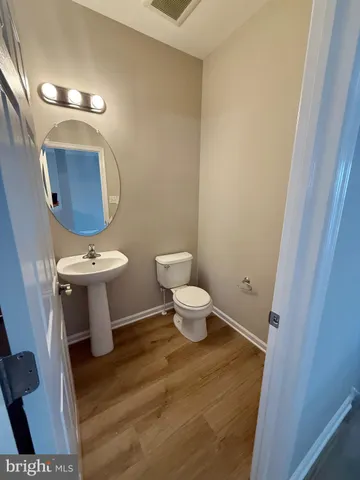 a view of a room with wooden floor and windows