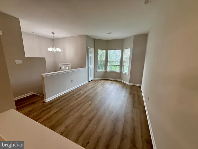 a view of workspace with wooden floor and staircase