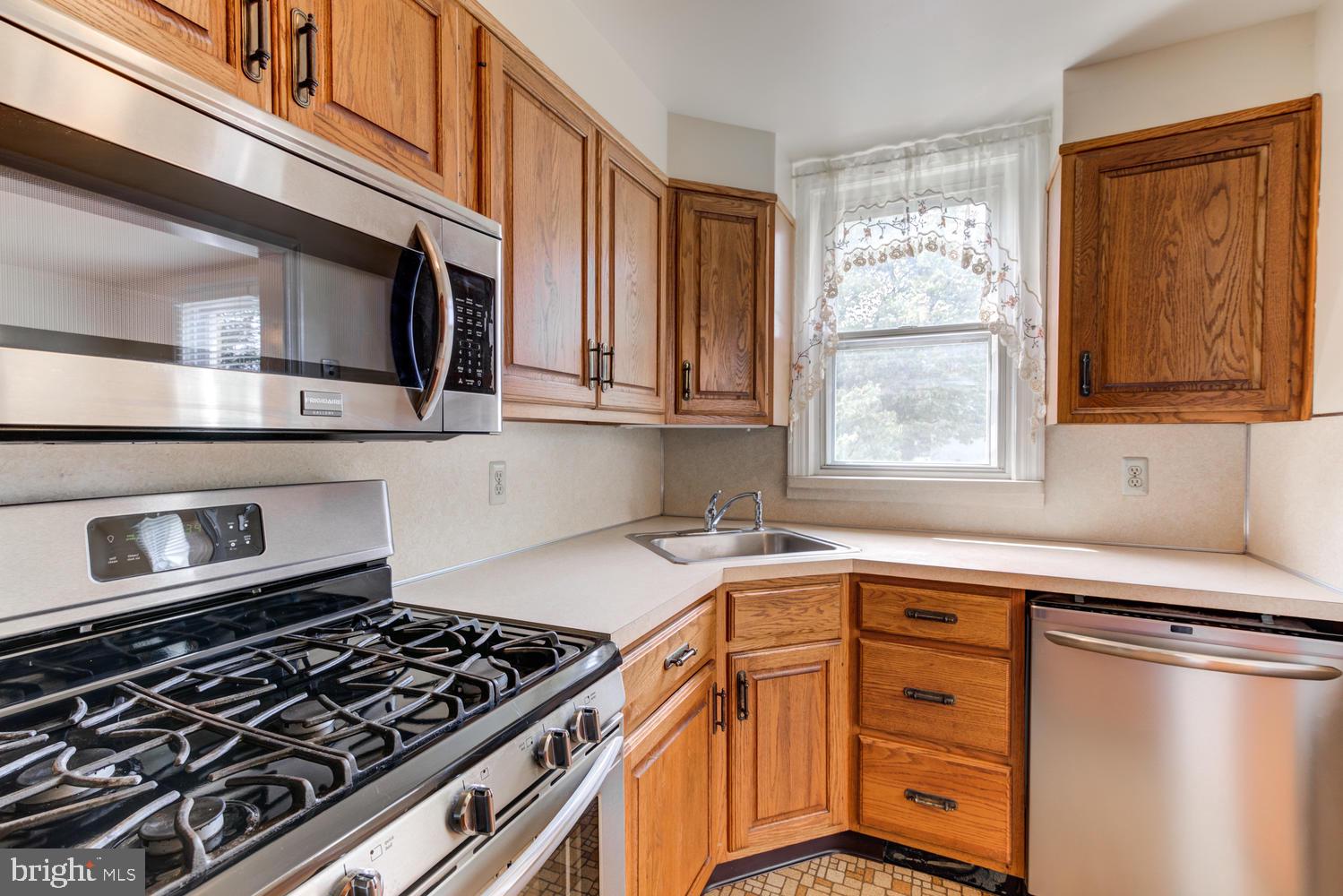 36 Woodbine Road Havertown, PA 19083 - Photo 11 of 34 a kitchen with stainless steel appliances granite countertop a stove and a microwave