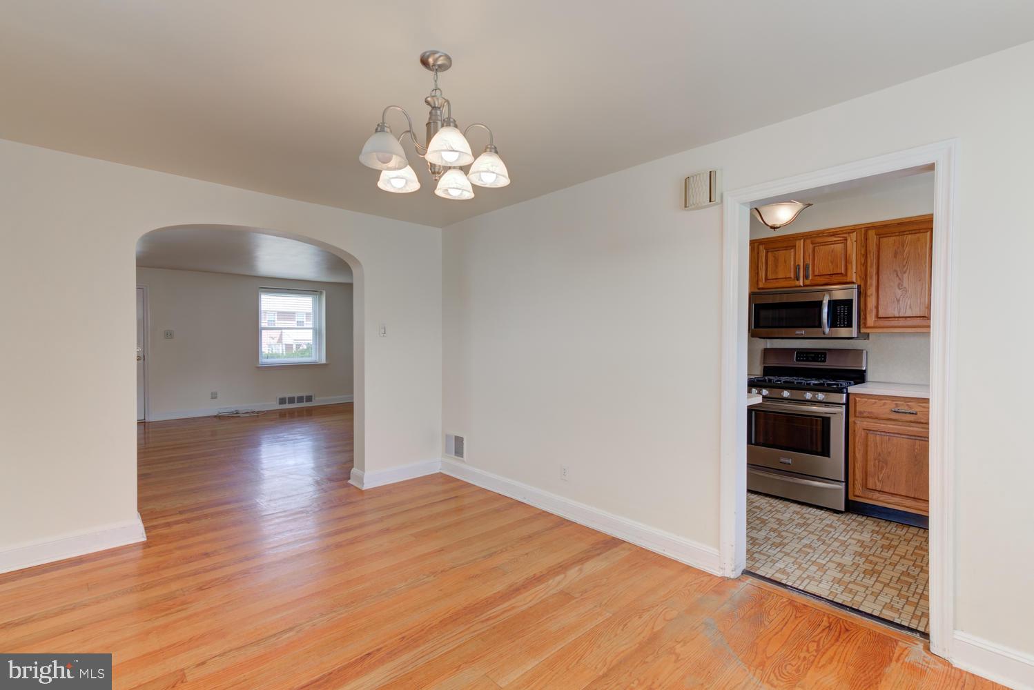 36 Woodbine Road Havertown, PA 19083 - Photo 17 of 34 a view of a kitchen with a stove wooden cabinet wooden floor and a kitchen view