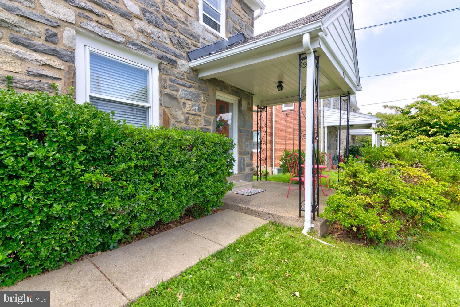 36 Woodbine Road Havertown, PA 19083 - Photo 3 of 34 a front view of a house with a yard and potted plants