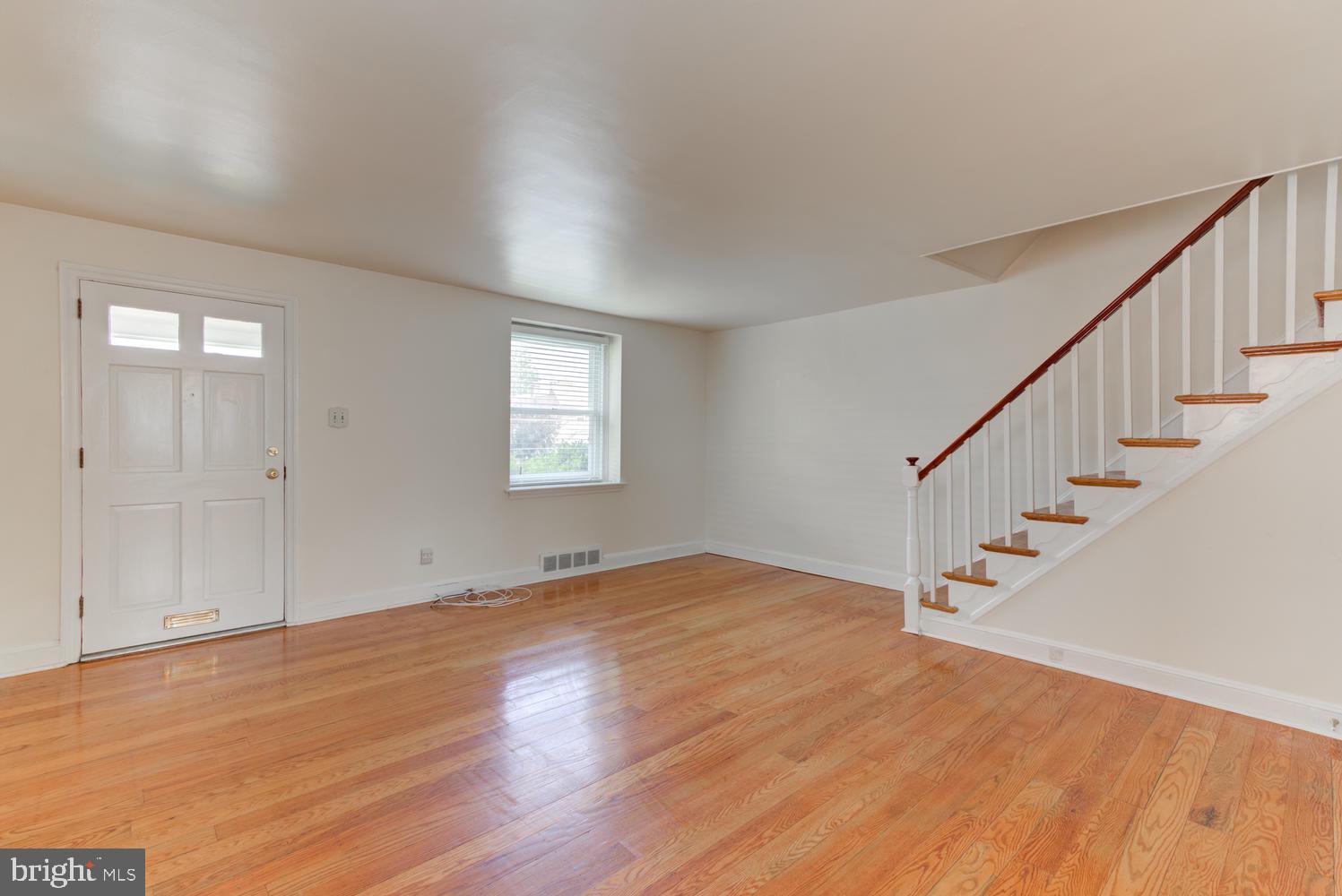 36 Woodbine Road Havertown, PA 19083 - Photo 21 of 34 a view of an empty room with wooden floor and stairs
