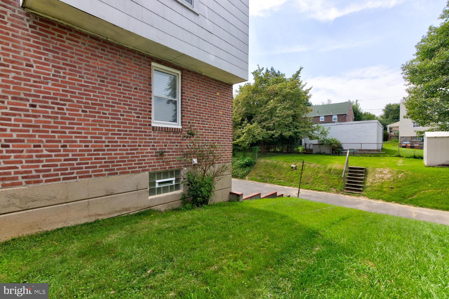 36 Woodbine Road Havertown, PA 19083 - Photo 5 of 34 a view of a house with a yard and a garden