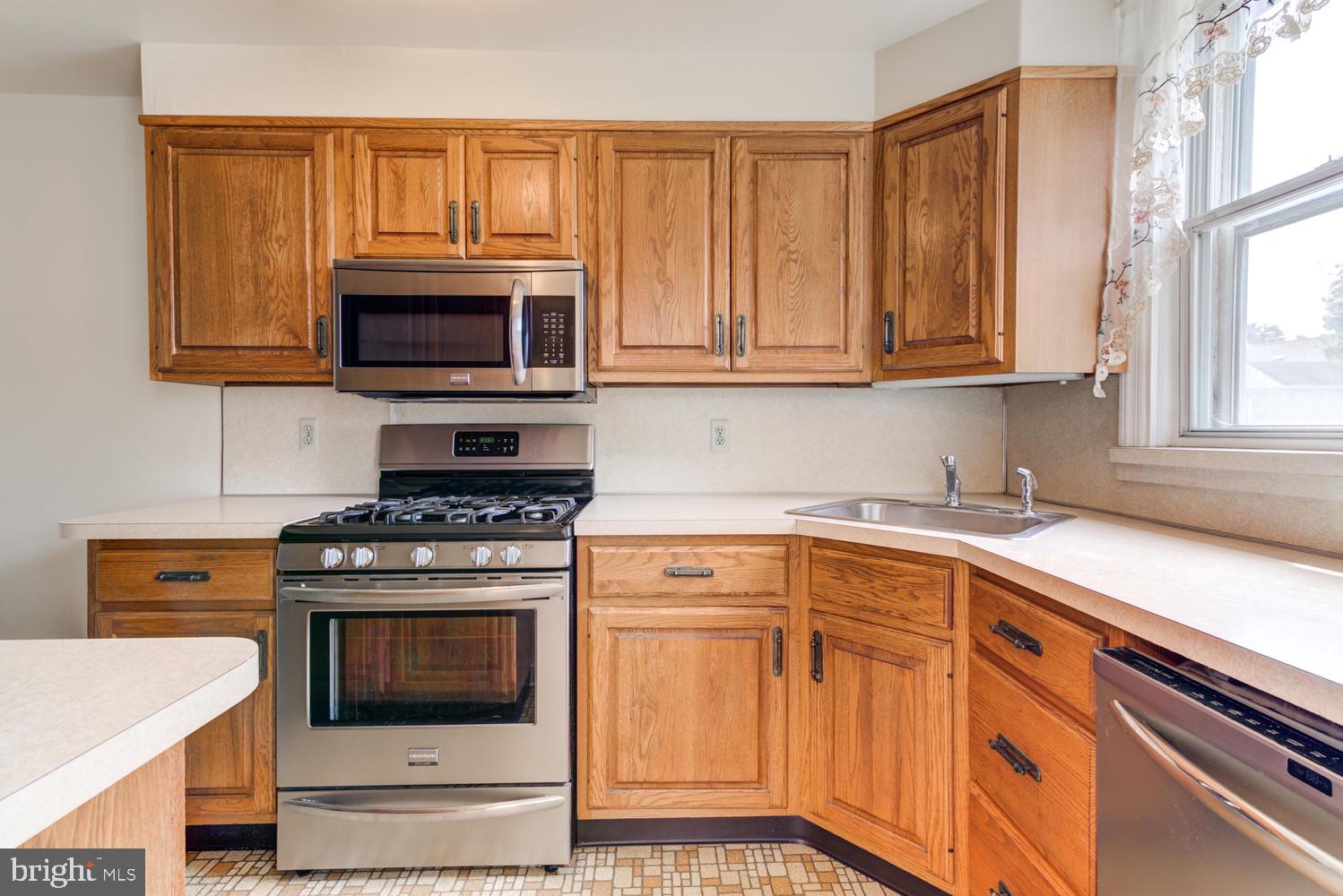 36 Woodbine Road Havertown, PA 19083 - Photo 8 of 34 a kitchen with granite countertop a stove top oven microwave and cabinets
