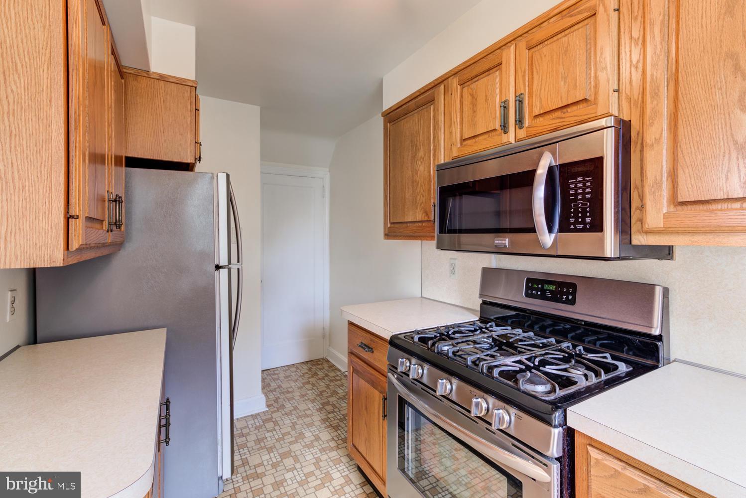 36 Woodbine Road Havertown, PA 19083 - Photo 9 of 34 a kitchen with stainless steel appliances granite countertop a stove a refrigerator and a microwave
