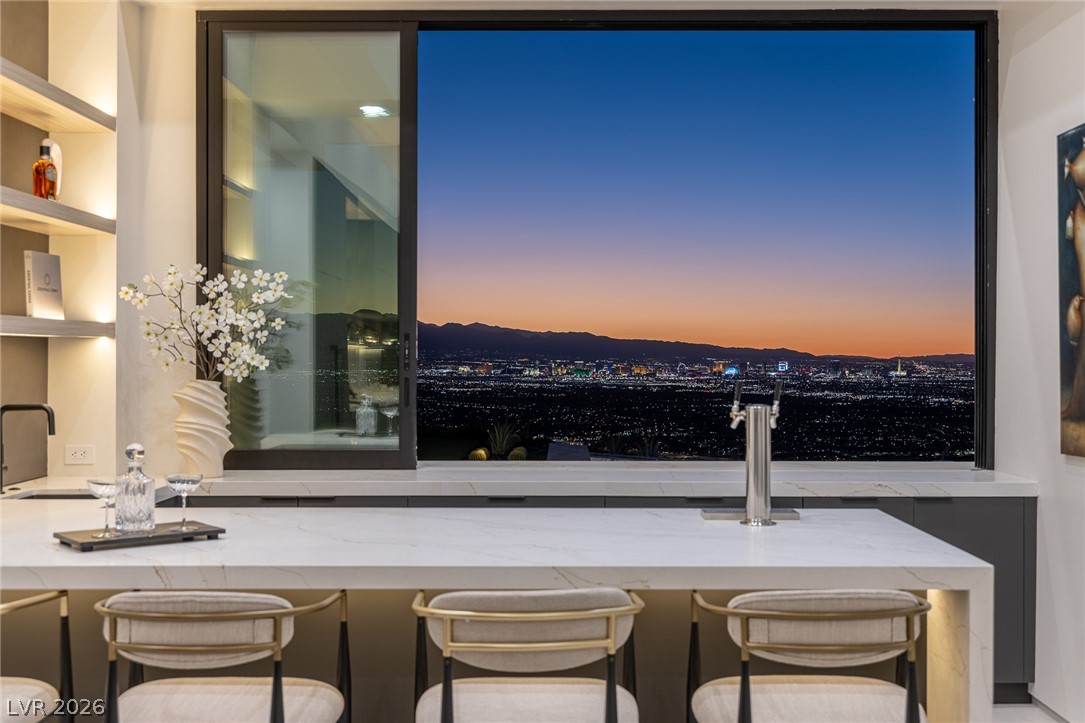 563 Grand Rim Drive Henderson, NV 89012 - Photo 45 of 70 An unparalleled view of city lights and distant mountains from this sophisticated wet bar.