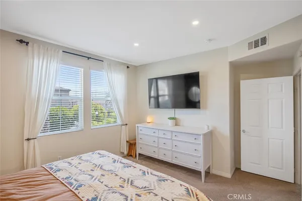 a bedroom with bed and a window
