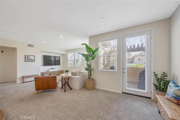 a living room with furniture a chandelier and a dining room