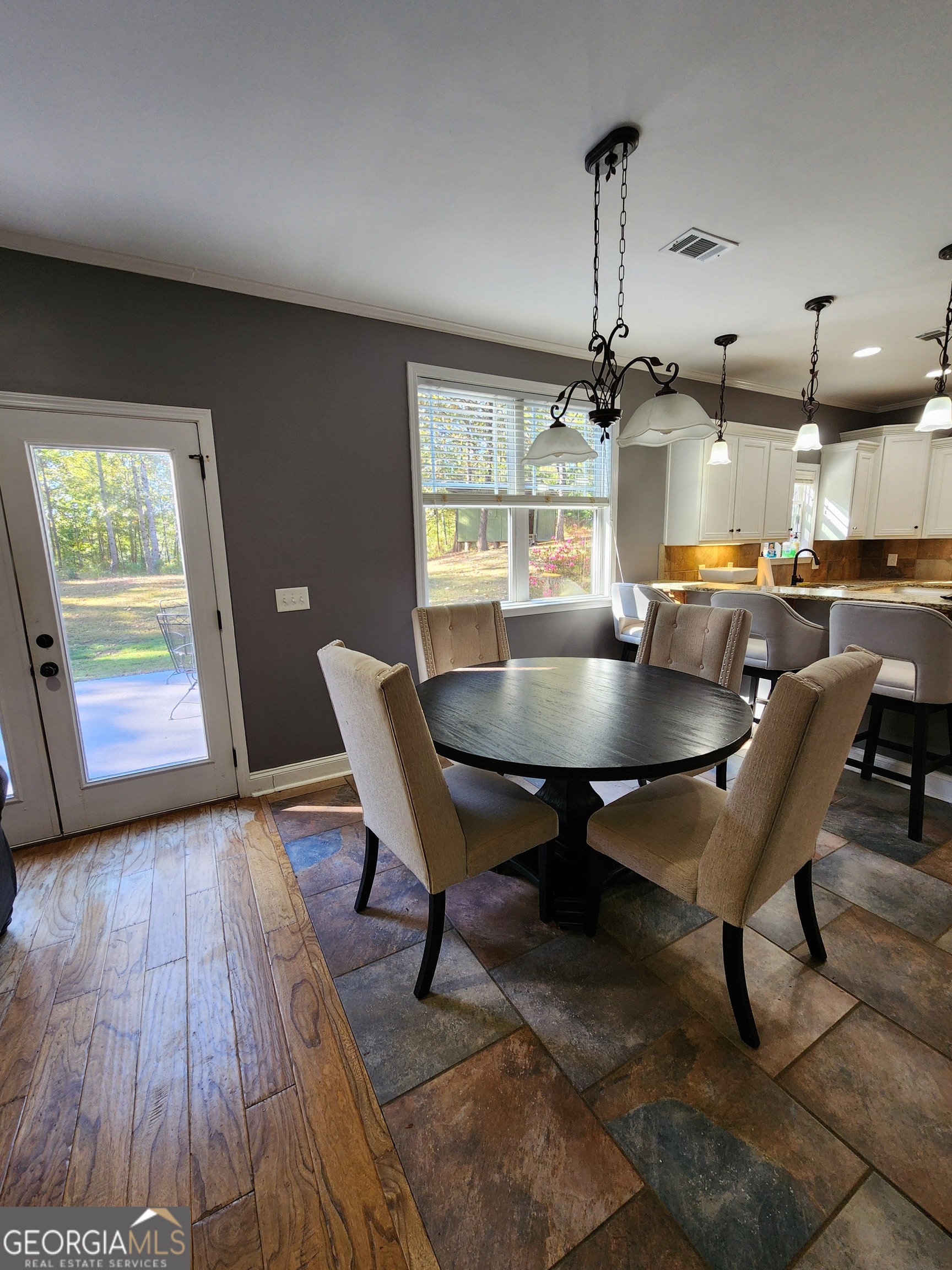 249 Serenity Loop Cataula, GA 31804 - Photo 14 of 44 a dining room with furniture a chandelier and wooden floor