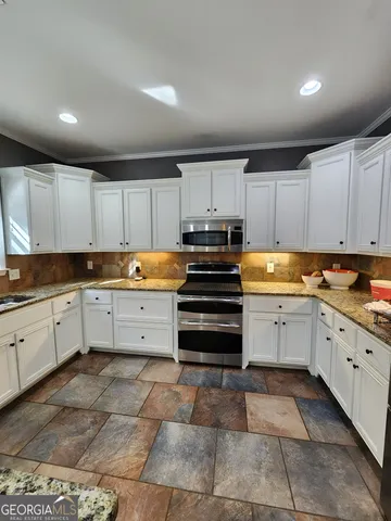 a kitchen with cabinets and appliances