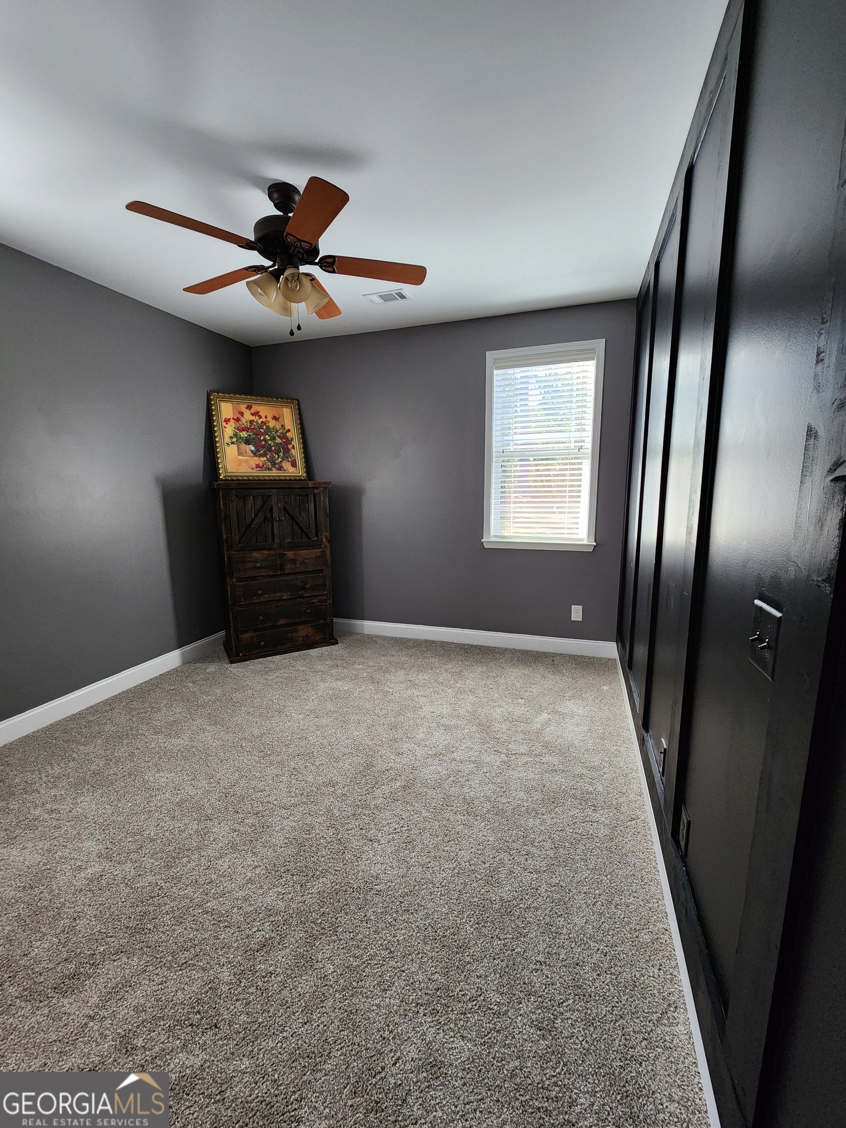 249 Serenity Loop Cataula, GA 31804 - Photo 22 of 44 an empty room with windows and fan