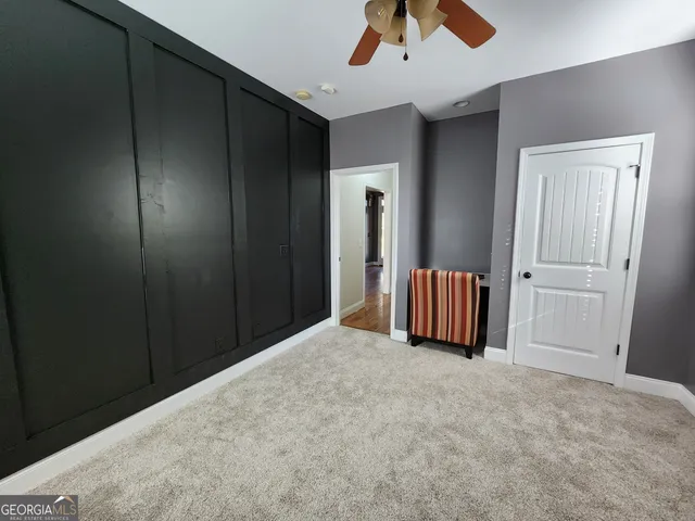 a bedroom with a bed and a mirror