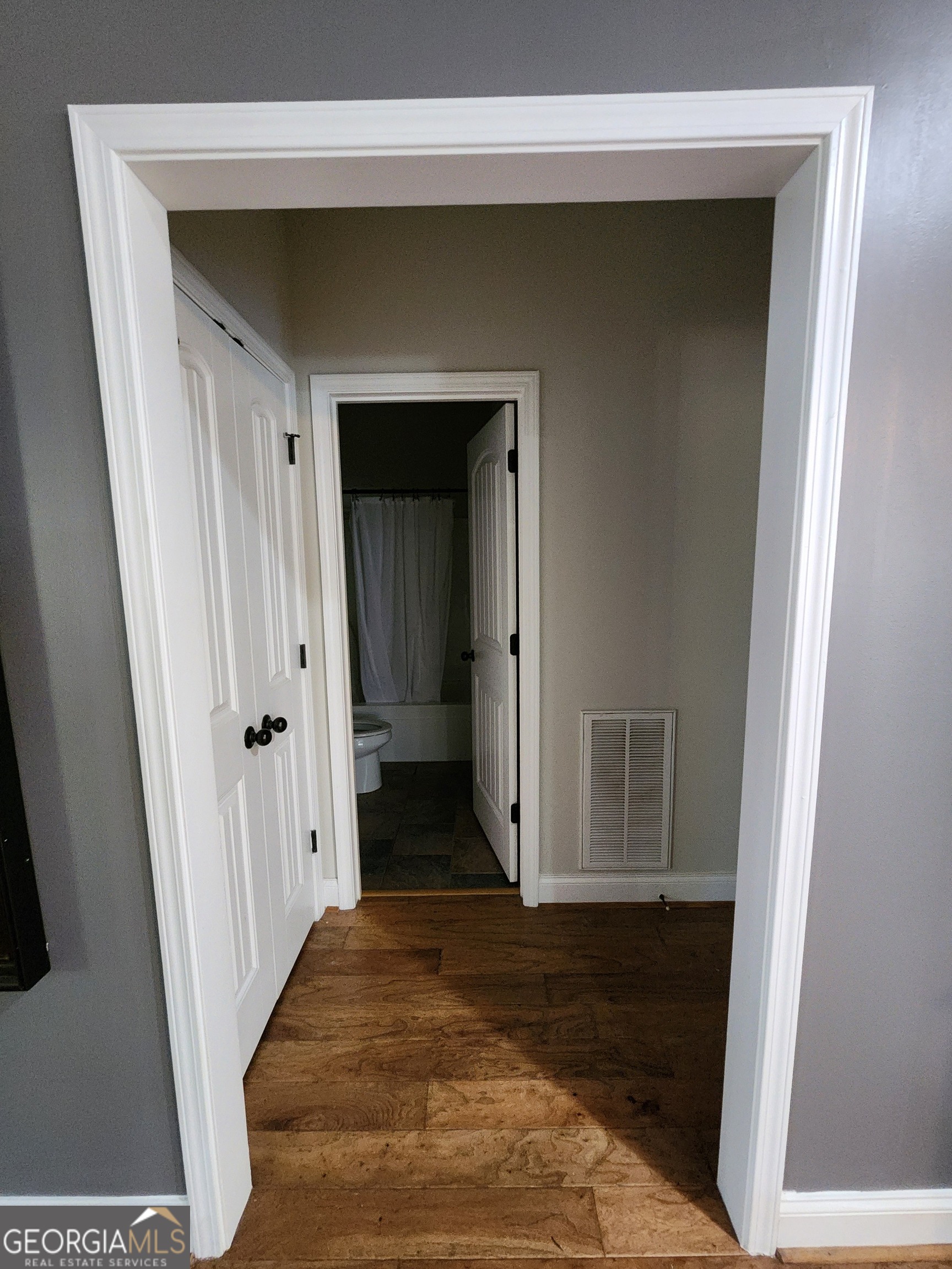 249 Serenity Loop Cataula, GA 31804 - Photo 25 of 44 a view of a hallway with wooden floor and a hallway