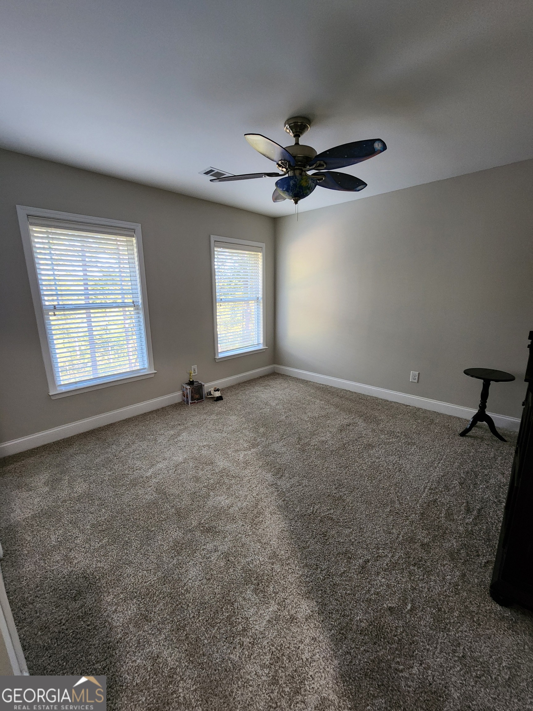 249 Serenity Loop Cataula, GA 31804 - Photo 33 of 44 a view of a livingroom with a ceiling fan and window