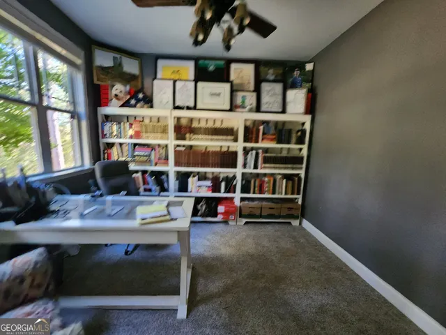 a room with lots of books and a large window