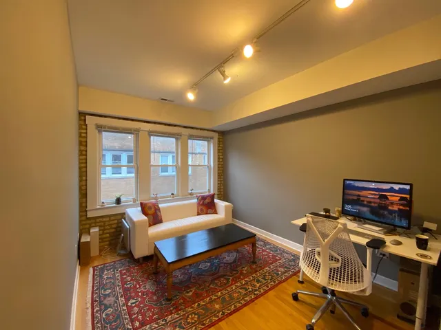 a living room with furniture and a floor to ceiling window