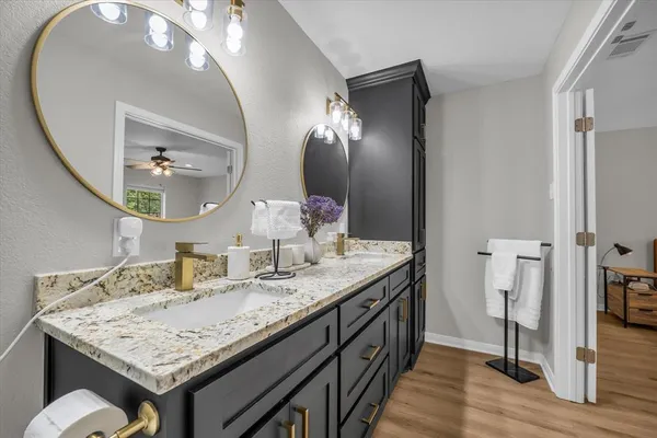 a bathroom with a toilet a sink and a mirror