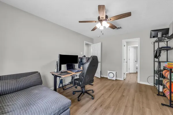 a view of a workspace with furniture and a window