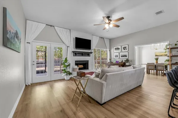a living room with furniture a flat screen tv and a fireplace
