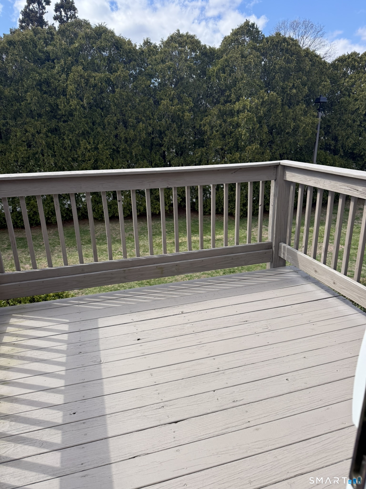 127 Black Point Road, Unit 31 East Lyme, CT 06357 - Photo 3 of 12 Balcony off of bedroom overlooks back yard.