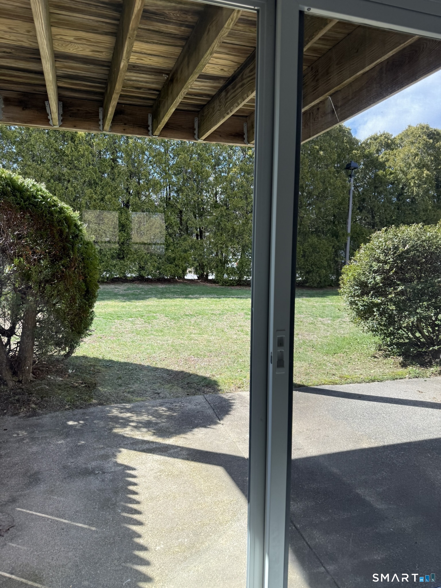 127 Black Point Road, Unit 31 East Lyme, CT 06357 - Photo 5 of 12 View from Living room through sliders to back/side yard.