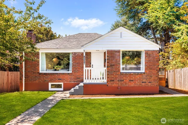 a front view of a house with a garden and yard