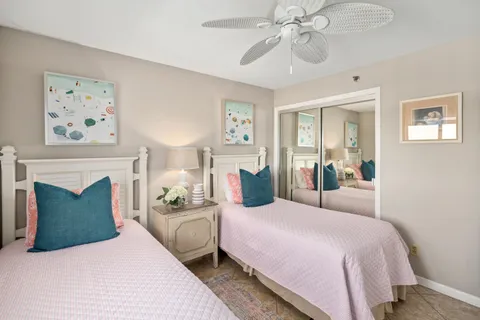 a bedroom with a bed and ceiling fan