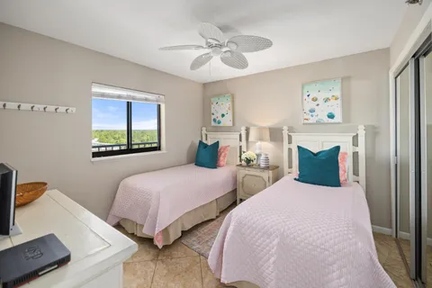 a bedroom with two beds and a window