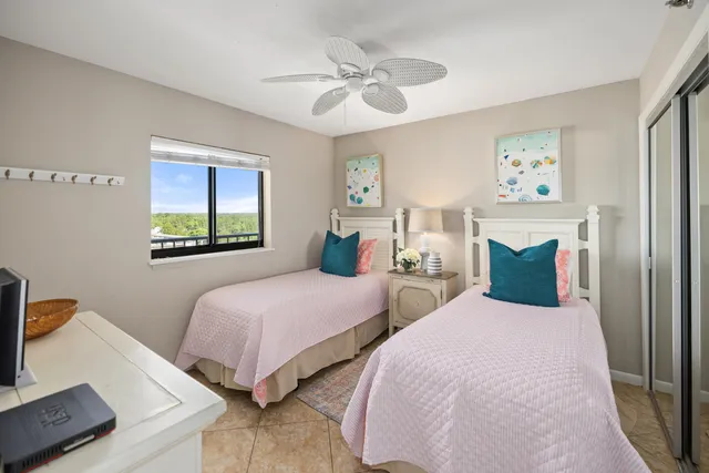 a bedroom with two beds and a window