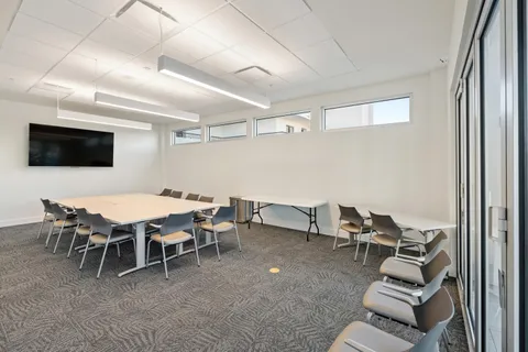 a dining room with furniture and a flat screen tv