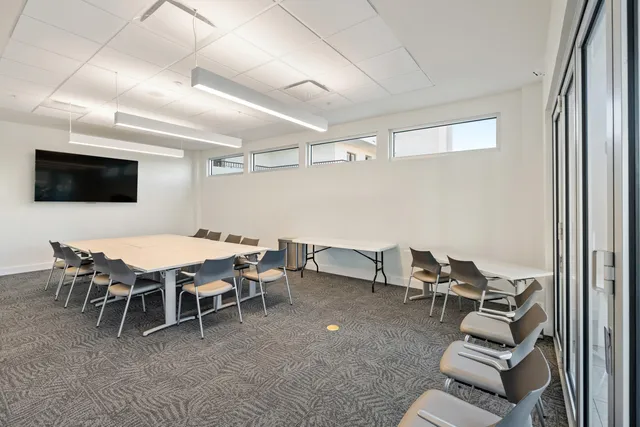 a dining room with furniture and a flat screen tv