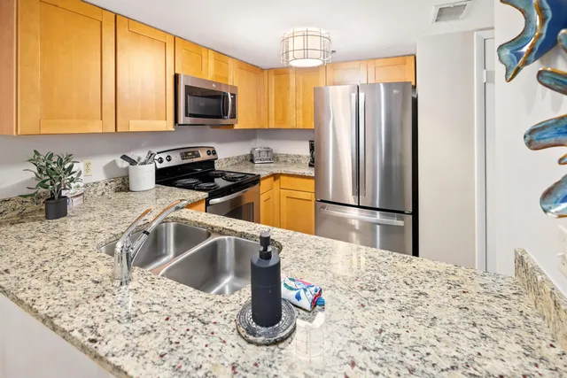 a kitchen with a refrigerator sink and microwave