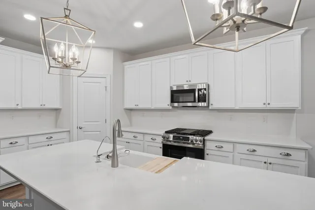 a view of a livingroom with wooden floor and a ceiling fan