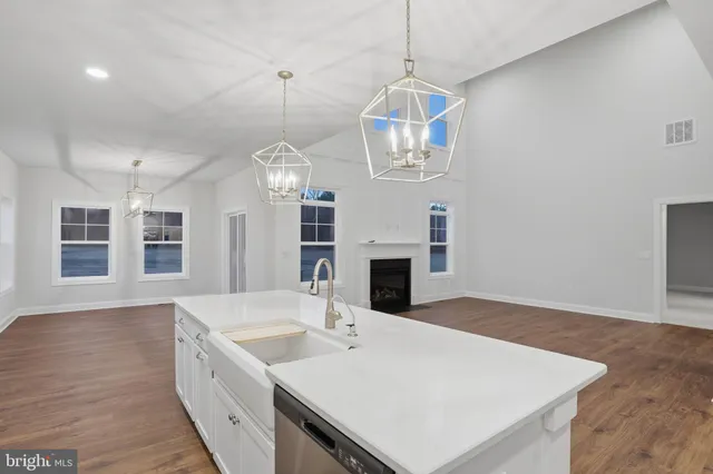 a view of wooden floor and windows in a room