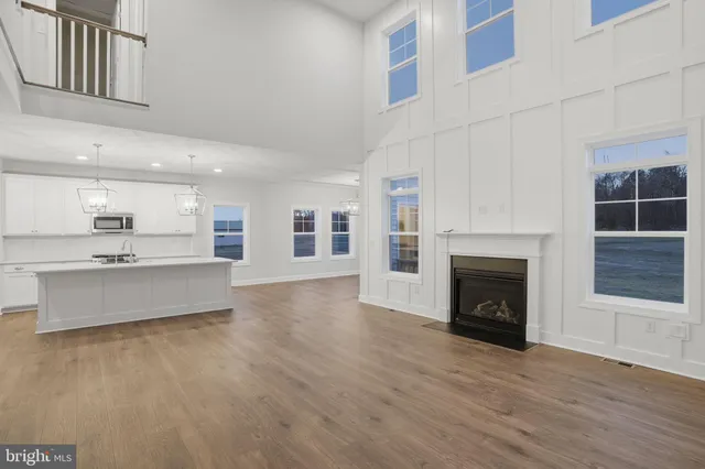 a large kitchen with granite countertop a large stove a sink dishwasher and a refrigerator with wooden floor