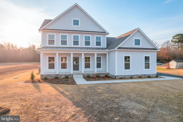 an empty room with wooden floor cabinet and entryway