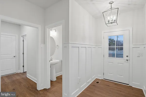 a view of a livingroom with wooden floor and a fireplace
