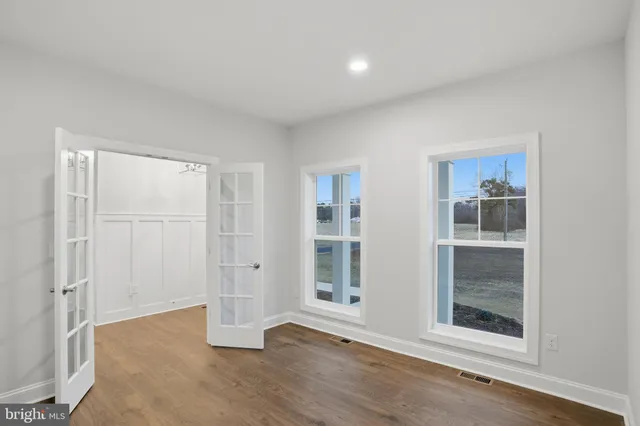 a kitchen with granite countertop a sink stainless steel appliances and white cabinets